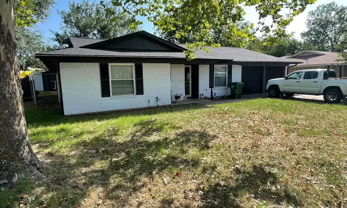 Professional roofing crew working on a residential roof in Terre Haute